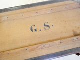 a wooden box with the word g s written on it