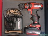 a cordless drill and a charger in a box