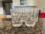 four glasses sitting on a counter in a kitchen