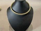 two necklaces that are on display on a table