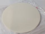 a white plate sitting on a plastic bag on a table