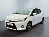 the toyota yaris is parked in a white room with a black floor