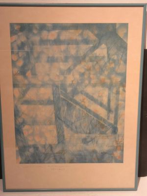 painting on the wall of a room with a chair and a table