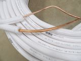 a close up of a coil of white electrical wires