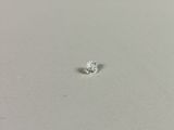 a close up of a single diamond on a white surface