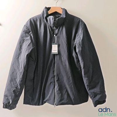 an image of a jacket hanging on a hanger on a wall