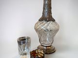 a glass and a bottle sitting next to each other on a table