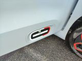 a close up of a car door handle with a tire