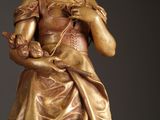 a statue of a woman holding a flower in her hands