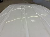 a close up of a white surfboard in a room