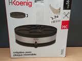 packaging of a black and silver food warmer on a wooden table