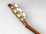 an image of a close up of a guitar neck with strings and knobs