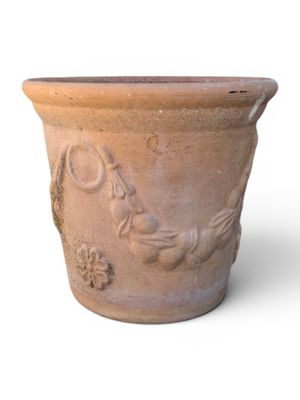 a clay pot with a bird and flower design on it
