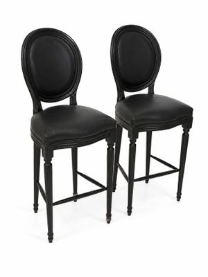 paire de tabourets de bar en cuir noir avec des dossiers ronds