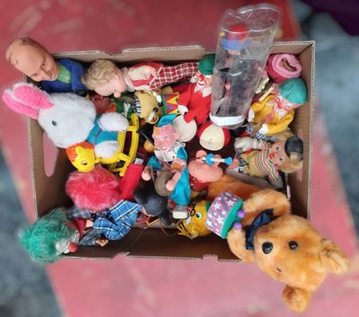 a box full of stuffed animals and toys on a table