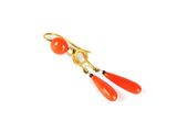 une photo d'une paire de boucles d'oreilles rouges rehaussées de touches dorées