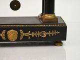 a black and gold clock with a lion head on it