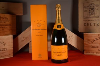 a bottle of champagne sitting next to a box of wine
