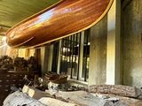 a large wooden boat hanging from the side of a building