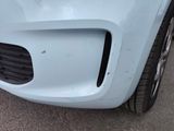 a close up of a car ' s front bumper with a hole in it