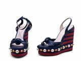 pair of blue and red wedges with pearls on the heel