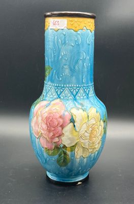 a blue vase with yellow and pink flowers painted on it