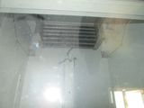 a radiator in the middle of a room with a window