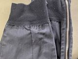 grey pants with zippers on the bottom and a zipper down the side