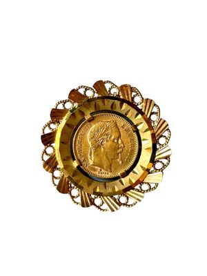 une assiette en or contenant une pièce de monnaie, sur fond blanc