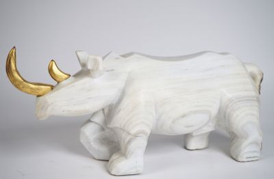 statue d'un rhinocéros blanc à la corne dorée sur fond blanc