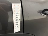 a sticker on the door of a car with a measuring tape attached to it