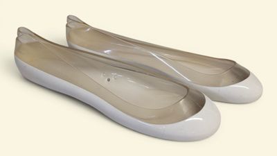 pair of women ' s white ballet shoes on a white surface
