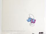une image représentant un Schtroumpf en train de dessiner sur une feuille de papier