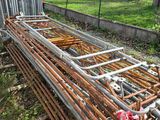 a pile of rusted metal bars in the grass