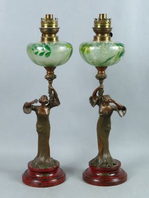 pair of antique bronze and green glass lamps on wooden bases