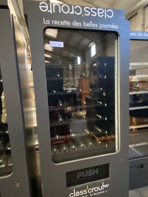 a vending machine in a store with a glass door