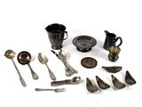 many different types of silverware on the table