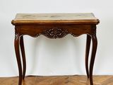 an image of a wooden table with a marble top on a parquet floor
