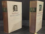 two books on a table with a picture of a man in a suit