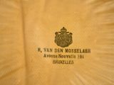 yellow polo shirt with a crown on the front and a black and white logo on the back