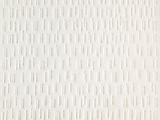someone is sitting on a bench in front of a white wall