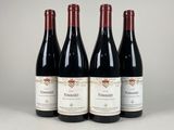 trois bouteilles de vin rouge posées sur une table blanche