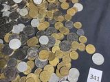 a pile of coins on a table with a price tag
