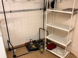 a closet with a rack and a washing machine in it
