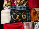 many different types of scarves laid out on a table
