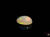 an image of a white fire opal in the dark