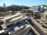 a pile of wood sitting on the ground in the yard