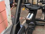 an image of a stationary exercise bike in a garage with other equipment