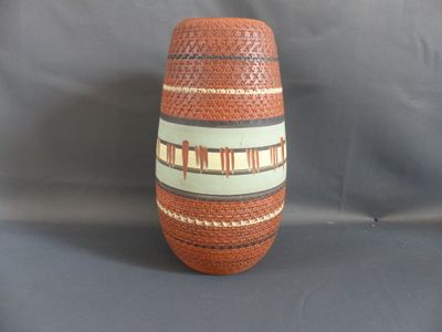 a vase that is sitting on a gray surface