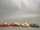 several toy cars are lined up in a row on a gray surface